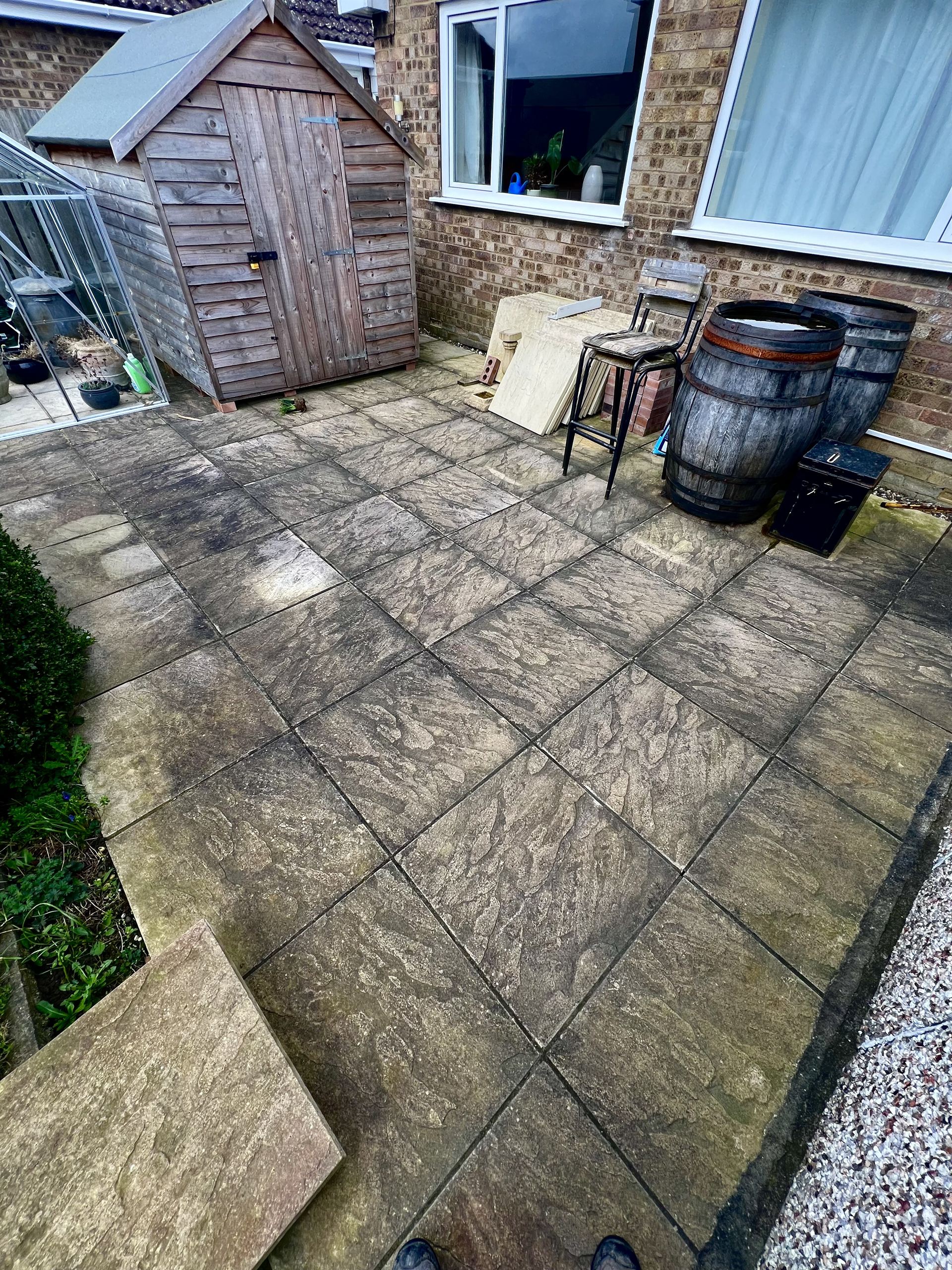 Block paving driveway in Malton covered in moss and weeds before pressure washing